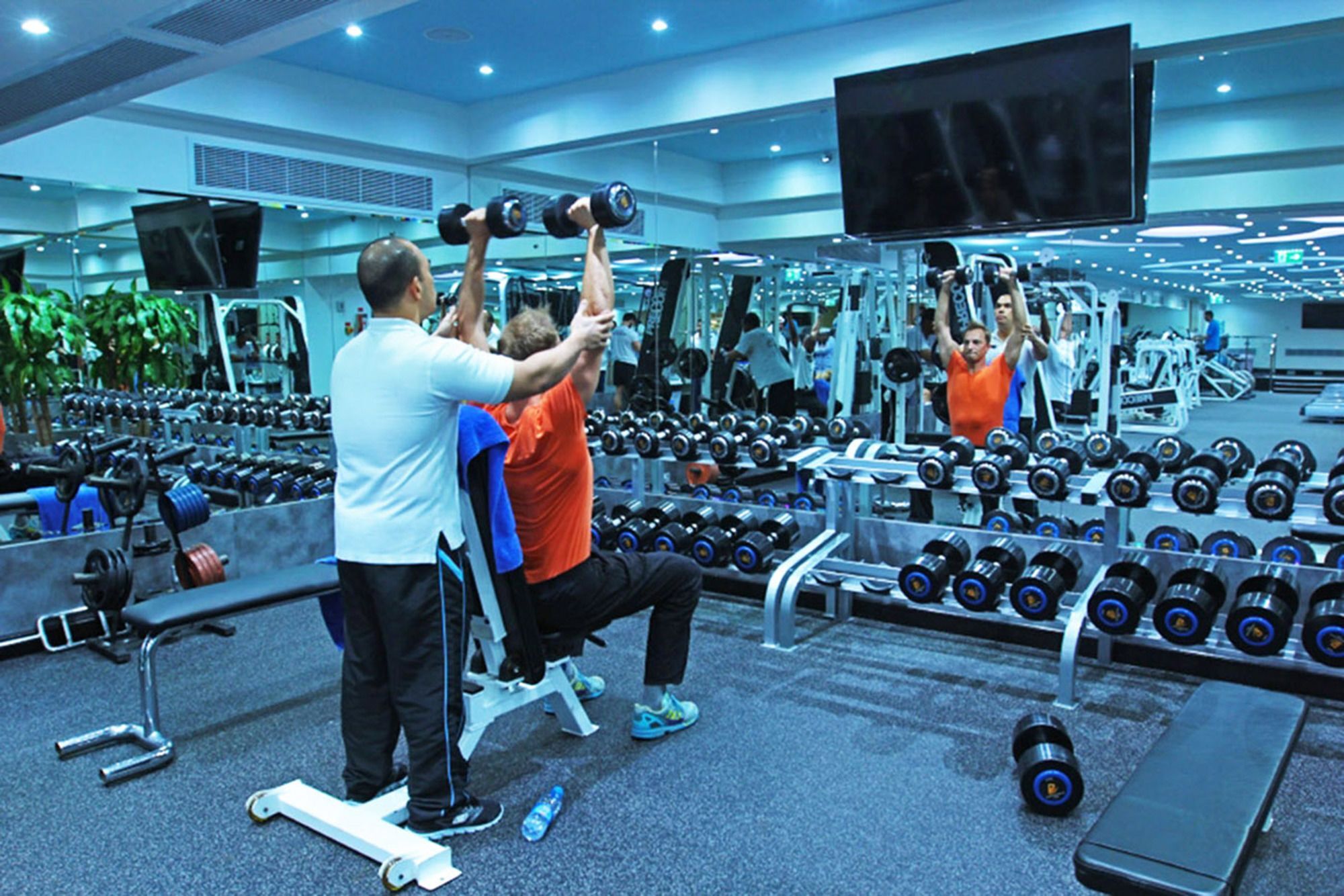 インターコンチネンタル アル ジュバイル Al Al Jubail エクステリア 写真 Personal trainer assisting a client with a dumbbell press
